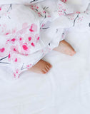 Malabar baby's 100% GOTS certified organic cotton super soft baby swaddle. Swaddle gets softer after every wash. The perfect newborn and baby shower gift. This swaddle has beautiful pink cherry blossoms on it with detailed grey branches. It's simply gorge